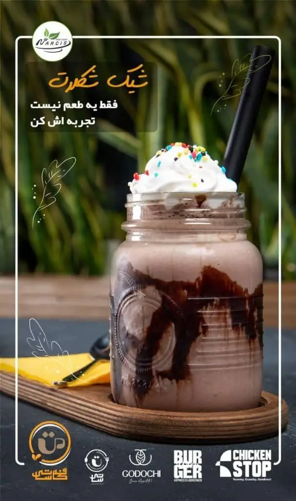 شیک شکلاتی خوشمزه با خامه فرم گرفته و اسپرینکل، در لیوان شیشه‌ای از فودهال نارسیس. یک دسر خنک و دلچسب.