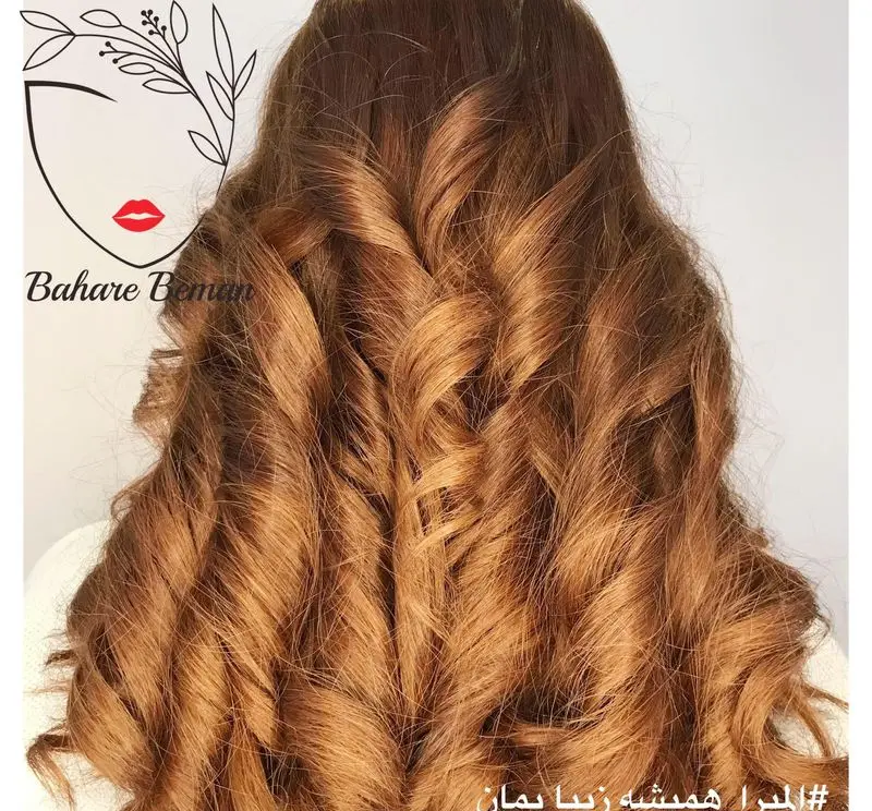 نمونه کار شینیون باز و موی کرلی با رنگ موی قهوهای عسلی در سالن زیبایی بهاره بمان، مناسب برای آرایش موی عروس و مجالس