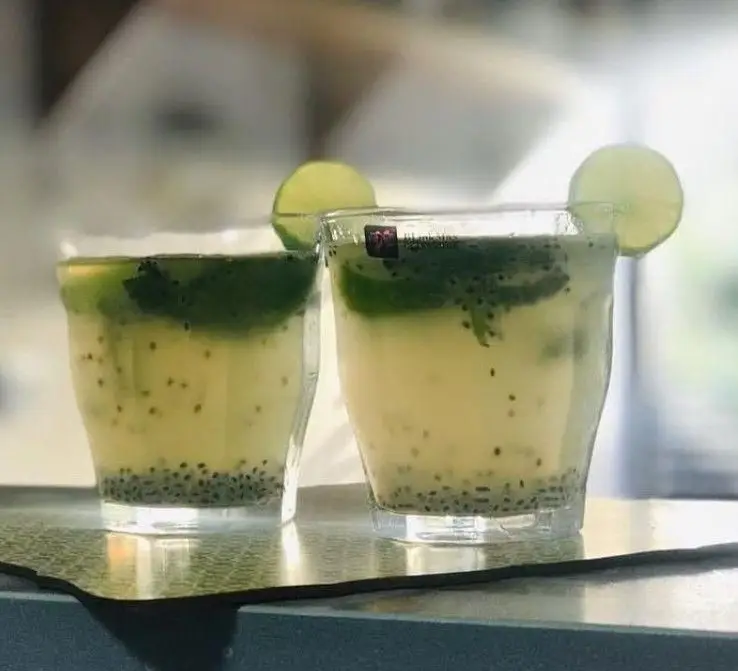 دو لیوان نوشیدنی لایه ای خنک کافه آفر، ترکیبی از بذر شربتی، لیمو و نعنا. گزینه‌ای عالی برای رفع عطش و لذت بردن از روزهای گرم تابستان.