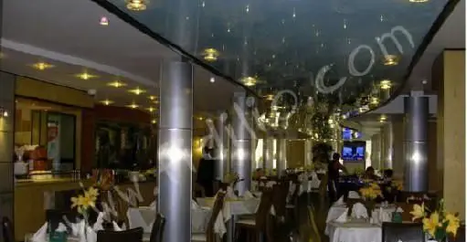 فضای داخلی شیک و مدرن رستوران البرز با میزهای چیده شده، دکوراسیون دلنشین و نورپردازی زیبا برای تجربه غذایی لذت‌بخش.