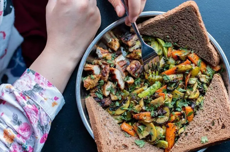 تجربه یک وعده غذایی سالم در کافه خیابون: مرغ گریل، سبزیجات تازه رست شده (هویج، کدو، قارچ) و نان تست قهوه‌ای. مناسب ناهار و شام.