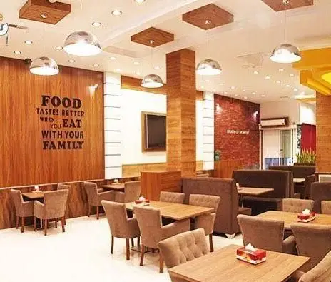 فضای داخلی گرم و دلنشین رستوران چیتر چیکن با دکوراسیون چوبی مدرن، میز و صندلی‌های راحت و نورپردازی زیبا برای تجربه غذایی خانوادگی.