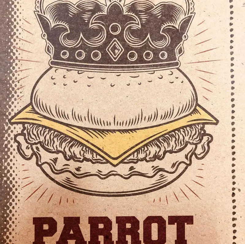 تصویری جذاب از یک برگر با تاج، نماد برگرهای ویژه و با کیفیت پیتزا تنوری پاروت. لوگو و نشان تجاری رستوران.