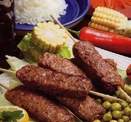 کباب‌های خوش‌طعم و آبدار به همراه برنج سفید، ذرت و سبزیجات تازه، بهترین انتخاب از کبابخانه دوزلی شعبه صادقیه.