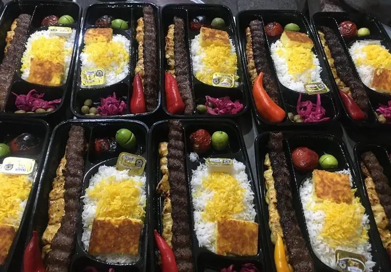 چلوکباب کوبیده و جوجه کبابی سیمرغ با ته دیگ، کره، زیتون، گوجه و پیاز ترشی. غذای ایرانی بیرون‌بر با کیفیت عالی.