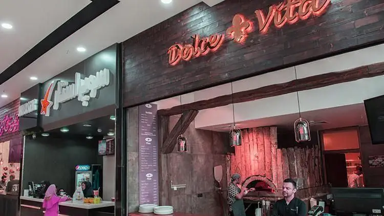 تصویری از فودکورت آرتمیس، محیطی پویا با کافه و رستوران‌های متعدد. مشتریان و پرسنل در حال ارائه و دریافت خدمات.