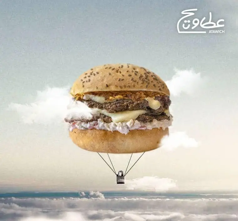 همبرگر عطاویچ فردوس غرب به شکل بالون هوای گرم در آسمان بالای ابرها. تبلیغ خلاقانه و جذاب برگرهای لذیذ عطاویچ.