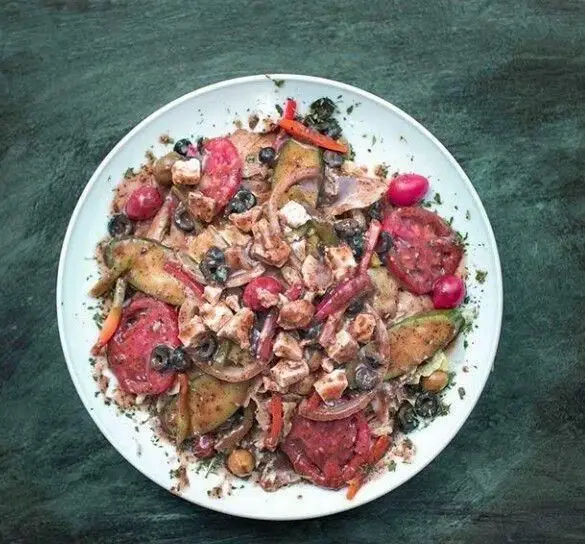 یک بشقاب بزرگ غذای سالم و متنوع از کافی شاپ لانجین شامل گوجه، زیتون، پنیر، سبزیجات و سس کرمی. گزینه‌ای عالی برای تجربه غذایی تازه در کافه لانجین.