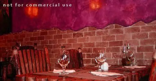 فضای داخلی دنج و دلنشین رستوران مورانو با دیوارهای آجری، میزهای چوبی چیدمان شده با لیوان و صندلی‌های شیک برای تجربه‌ای لذت‌بخش.