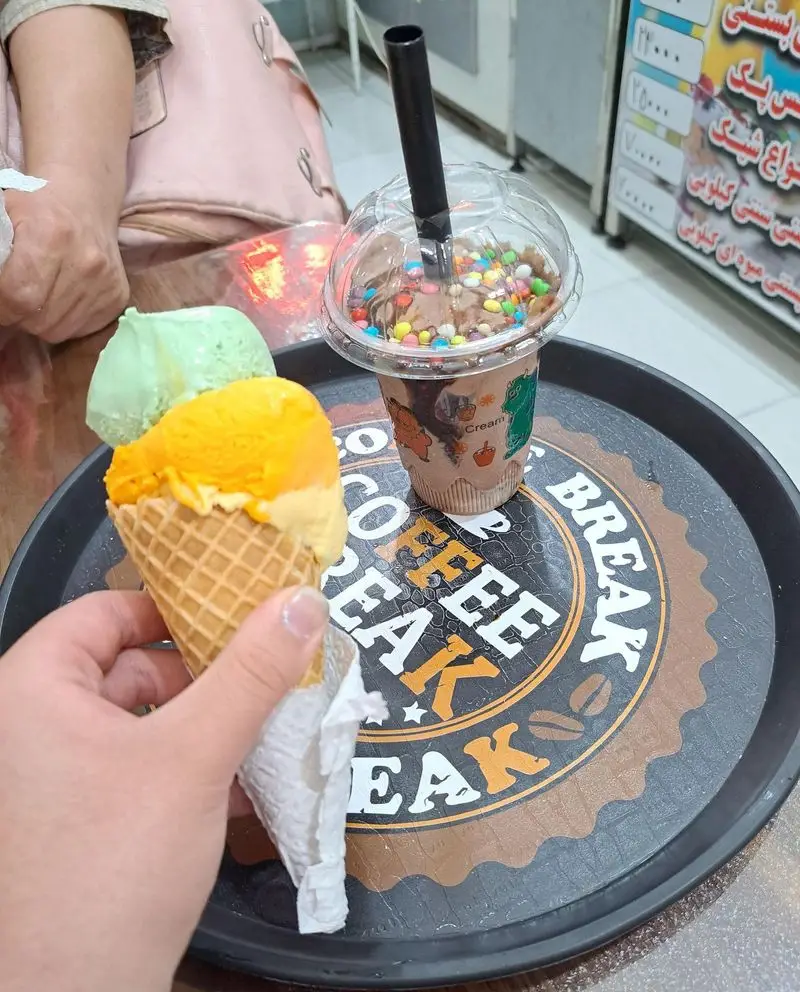 لذت یک استراحت شیرین در ویتامینه سعید؛ با بستنی قیفی دو اسکوپ میوه ای و شیک شکلاتی رنگارنگ و خوشمزه.