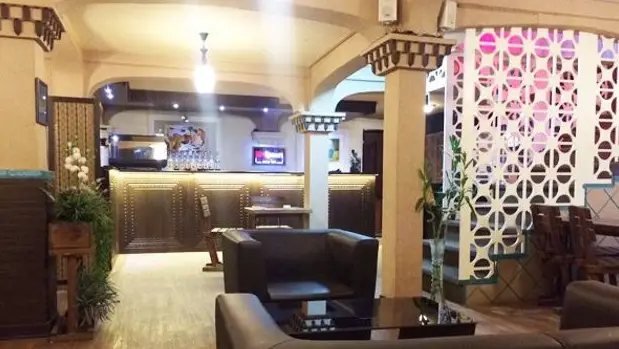 فضای داخلی کافه سفره خانه آلما با دکوراسیون شیک و تلفیقی از مدرن و سنتی، مبلمان راحت و بار نوشیدنی‌ها برای تجربه‌ای دلنشین.