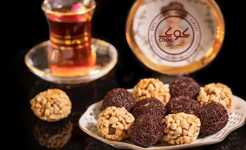 شیرینی‌های شکلاتی و آجیلی خوشمزه کافه قنادی کوک همراه با چای داغ؛ انتخابی شیرین برای لحظات دلپذیر شما.