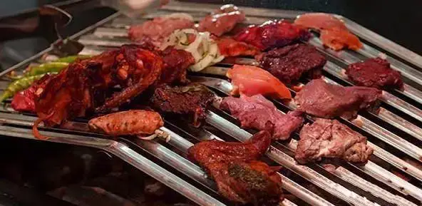 کباب انواع گوشت تازه شامل مرغ، گوساله، جگر و دل بهمراه فلفل و پیاز روی گریل داغ در رستوران اجاق باشی، انتخابی لذیذ و سالم.