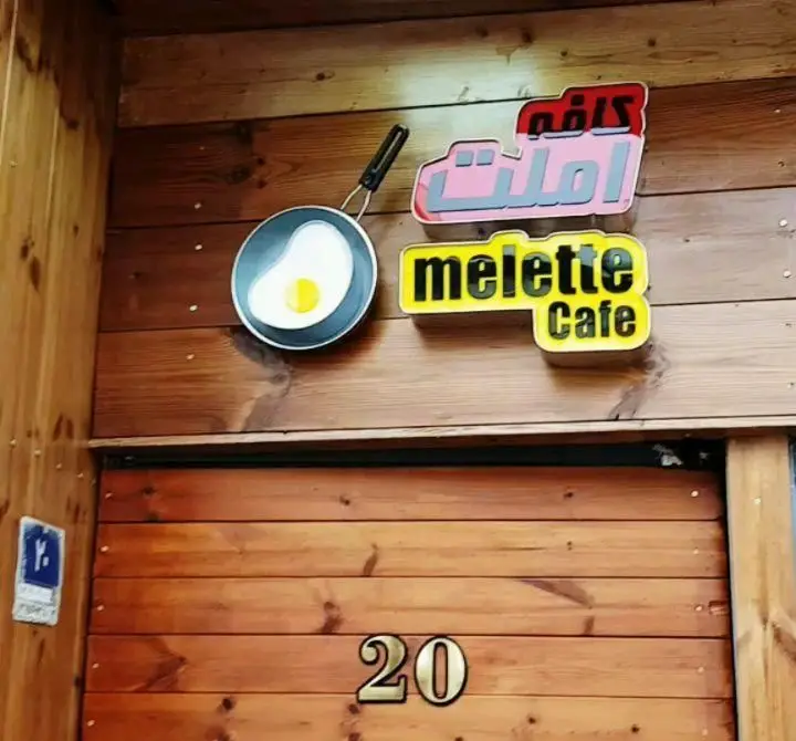 نمای جذاب کافه املت و Melette Cafe با لوگوی نیمرو در ماهیتابه و پلاک ۲۰ روی درب چوبی، متعلق به مجموعه گزینگ برگر.