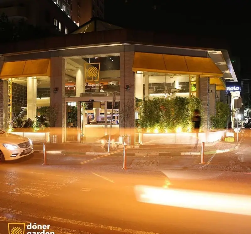 نمای شبانه و جذاب رستوران دونر گاردن با طراحی مدرن، نورپردازی گرم و محیطی دلنشین در خیابان برای تجربه غذای دونر.