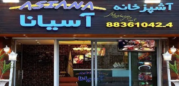تصویر نمای بیرونی آشپزخانه و رستوران آسیانا با تابلوی روشن و شماره تماس 88361042-4، نمایش دهنده غذاهای خوشمزه.