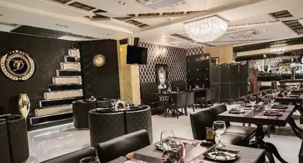 فضای داخلی لوکس کافه فرانسوی ویوات با دکوراسیون شیک، میز و صندلی‌های مدرن، لوستر کریستالی و بار نوشیدنی.