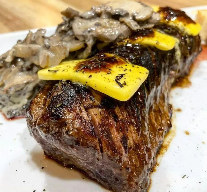 استیک گریل آبدار کافه رستوران مکث با کره ذوب شده و سس قارچ خامه‌ای، یک انتخاب لذیذ برای تجربه غذای عالی در Maks.