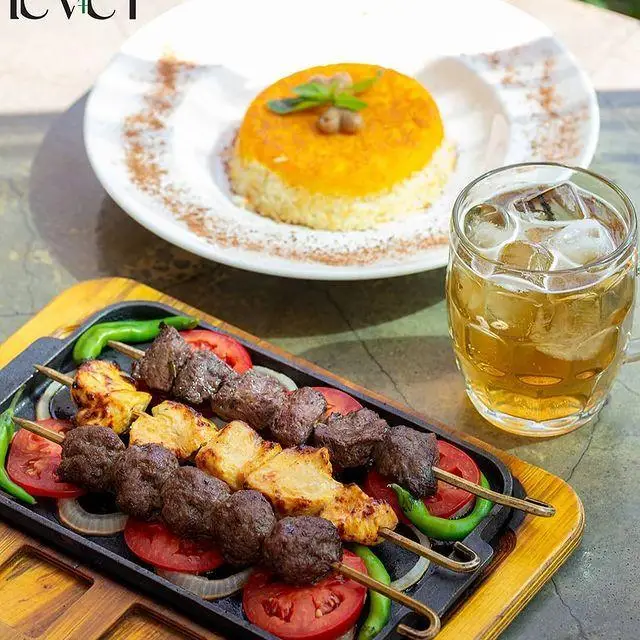 کباب کوبیده و جوجه کباب در کافه رستوران لول ۴، به همراه ته چین مجلسی و نوشیدنی خنک. تجربه‌ای دلنشین از غذای ایرانی.