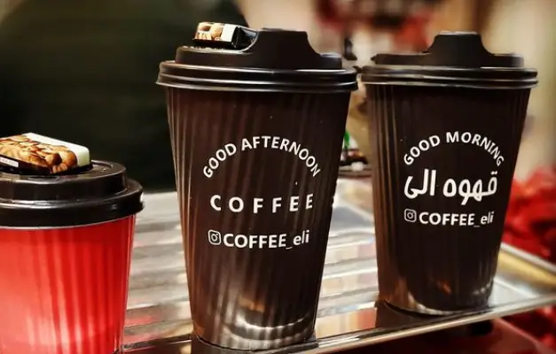 فنجان‌های قهوه بیرون‌بر با لوگوی قهوه الی و متون صبح بخیر و عصر بخیر، از کافه @COFFEE_eli. طراحی زیبا و مناسب برای سفارش قهوه.