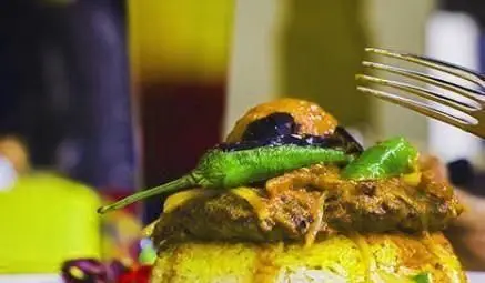 سفارش غذای اصلی و لذیذ در کافی شاپ ایوان: کباب با برنج زعفرانی، فلفل سبز و سس مخصوص. تجربه‌ای دلنشین و خوشمزه.