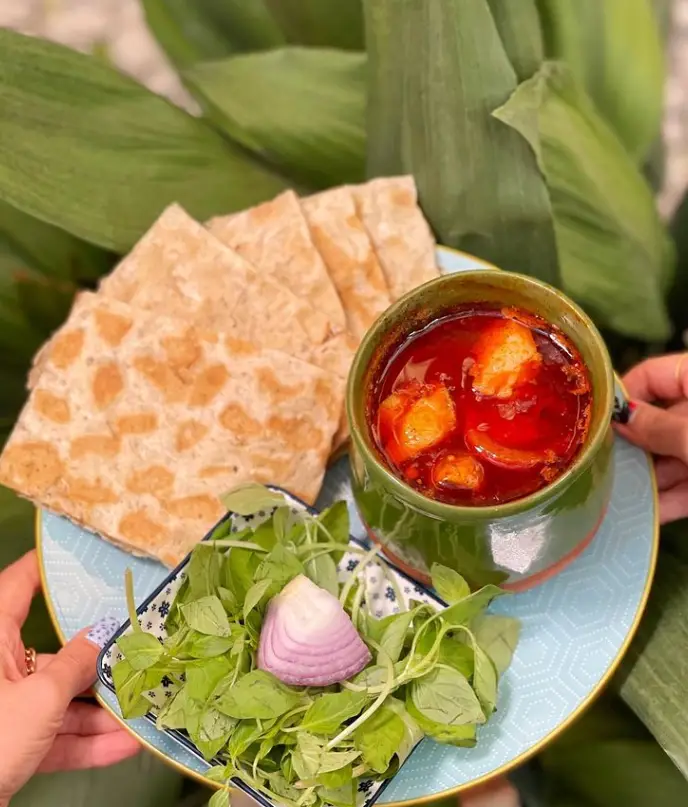 تصویری جذاب از دیزی سنتی و لذیذ رستوران دیزی دیدار، سرو شده با نان تازه، سبزی خوردن و پیاز. تجربه طعم اصیل ایرانی.