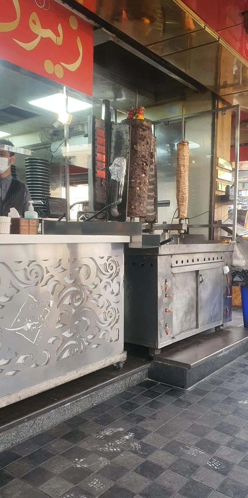 تصویری از رستوران فست فود زیتون، نمایشگر آماده‌سازی شاورماهای گوشت و مرغ تازه و خوش‌طعم در محیطی بهداشتی و مدرن.