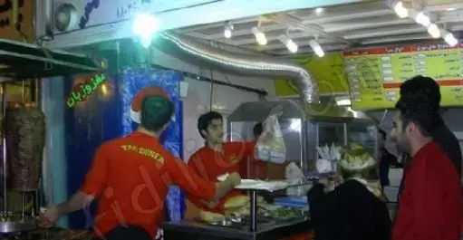 کسب و کار ساندویچ تک دنر: پرسنل در حال تهیه دنر کباب و شاورما لذیذ برای مشتریان در یک فست فود پرطرفدار.