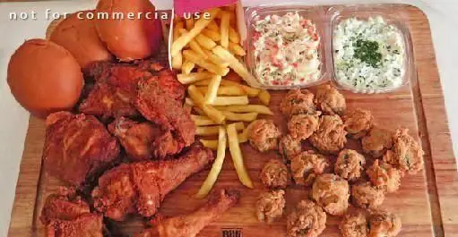 سرویس کامل مرغ سوخاری دی شامل تکه‌های مرغ، سیب‌زمینی، نان، سالاد و قارچ سوخاری برای یک وعده فست فود خوشمزه.