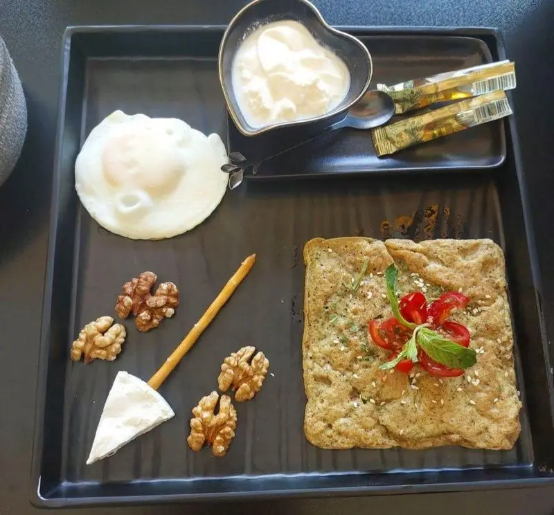 صبحانه کامل و خوشمزه در کافه قلیان عربی A&M: املت، تخم مرغ، ماست، پنیر و گردو. وعده‌ای دلنشین و انرژی‌بخش برای آغاز روز شما.