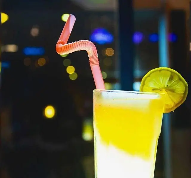 نوشیدنی لیموی خنک و لذیذ با نی فانتزی و لیموترش تازه در کافه رستوران داریما، محیطی دلنشین برای شب‌های تابستان.