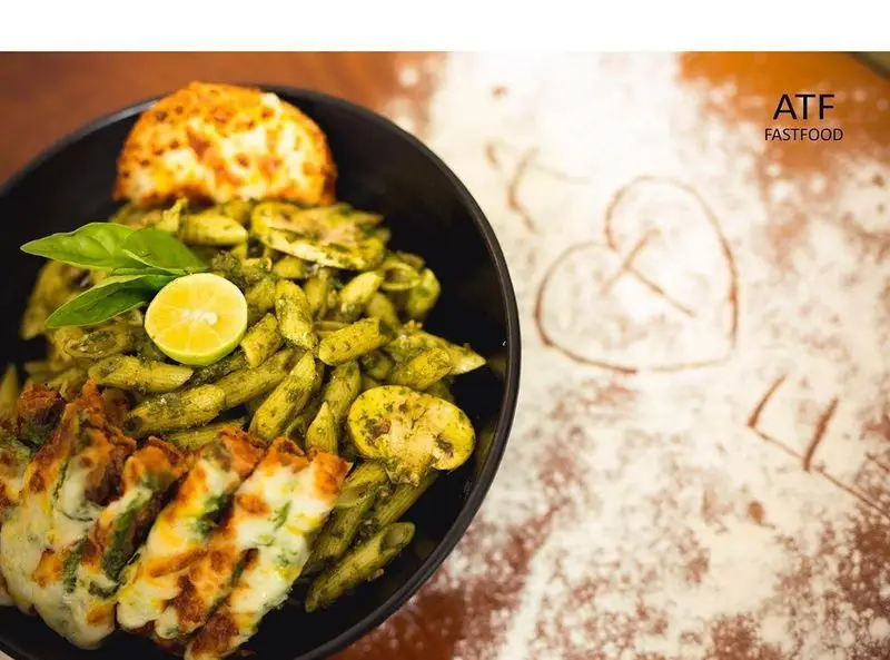 پاستا پنه پستو و قارچ با سس سبز، لیمو و پنیر در رستوران ای تی اف. یک غذای فست فود خوشمزه با تزئین رمانتیک.