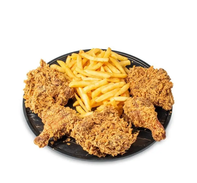 پنج تکه مرغ سوخاری ترد و طلایی با حجم زیادی سیب زمینی سرخ کرده داغ و خوشمزه در بشقاب گرد مشکی از فست فود کامنت