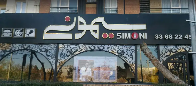 تابلوی کافه رستوران سیمونی شامل نام SIMONI، آیکون‌های غذا (همبرگر، پیتزا، مرغ سوخاری) و شماره تلفن 33682245 برای رزرو و سفارش.