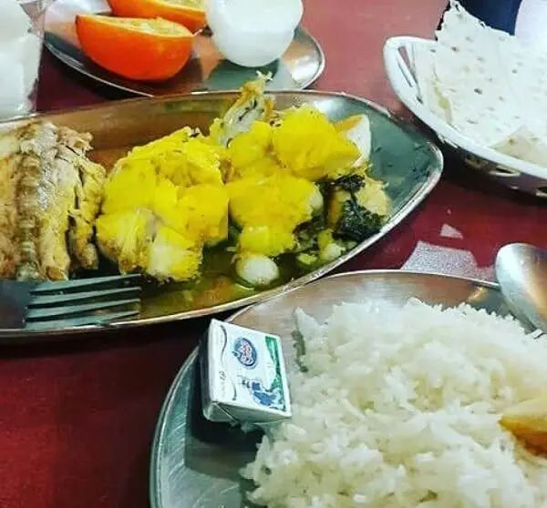 یک وعده غذایی کامل و لذیذ در رستوران لاکان: برنج ایرانی، خورش مجلسی زرد، مرغ یا ماهی سرخ شده با نان تازه و پرتقال.
