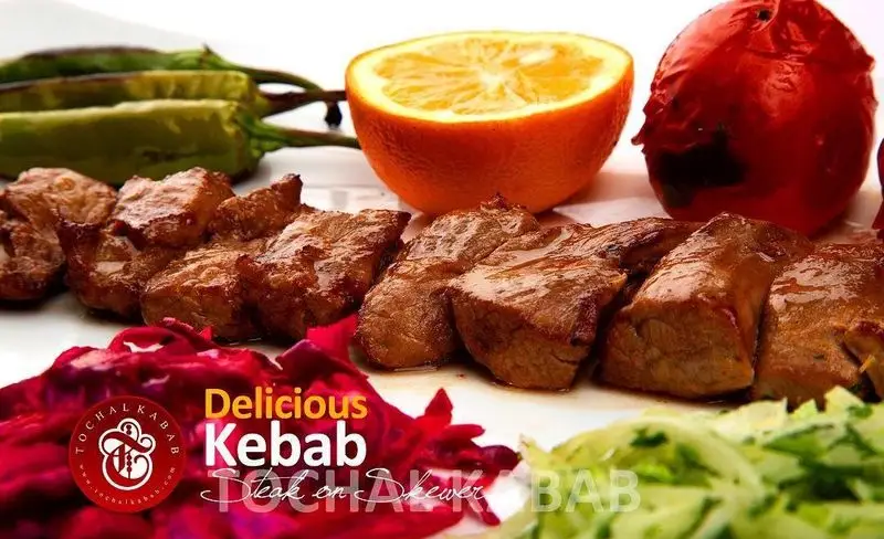کباب برگ خوشمزه و آبدار توچال با گوشت تازه، همراه با فلفل، گوجه کبابی، پرتقال و سالاد در کباب سرای توچال.