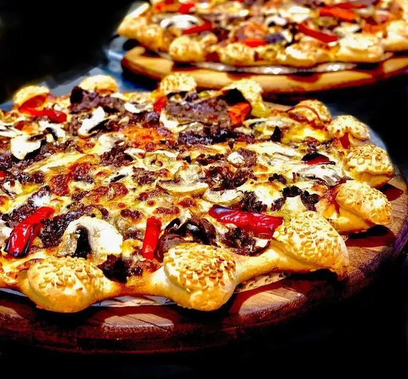 پیتزا شب، پیتزای لذیذ و پرطرفدار گوشت و قارچ با کراست لقمه‌ای جذاب و دانه کنجدی، آماده سفارش آنلاین و حضوری. طعمی بی‌نظیر.