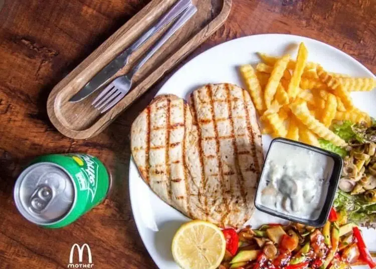 سینه مرغ گریل خوش طعم فست فود مادر با سیب زمینی سرخ کرده، سبزیجات تازه، سس قارچ، لیمو و نوشابه اسپریت برای یک وعده کامل.