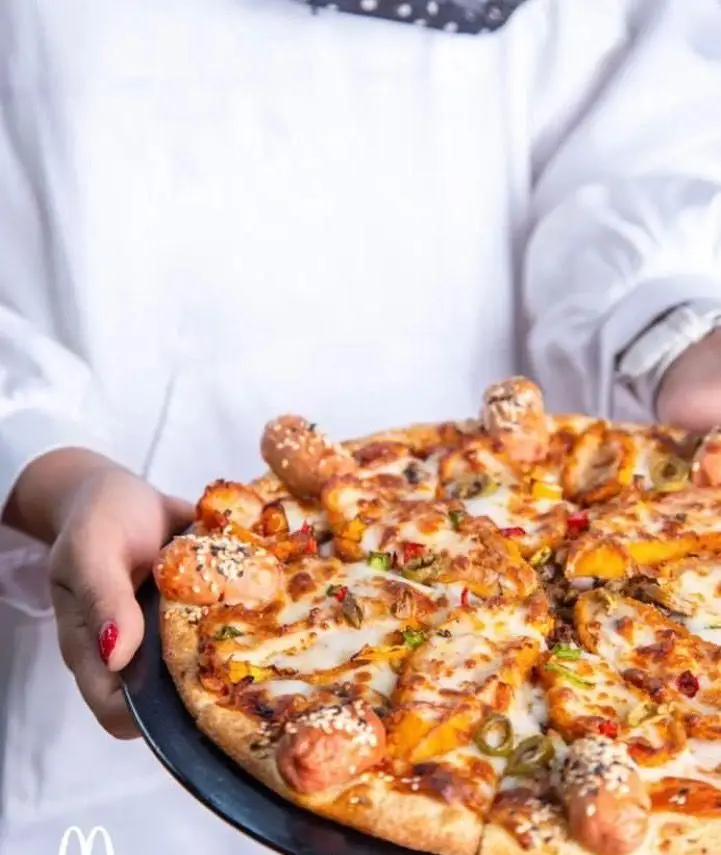 پیتزا ویژه و خوشمزه فست فود مادر شامل کراست سوسیس، تکه‌های مرغ، سبزیجات تازه و پنیر فراوان. تجربه‌ای لذیذ از غذای باکیفیت و داغ.