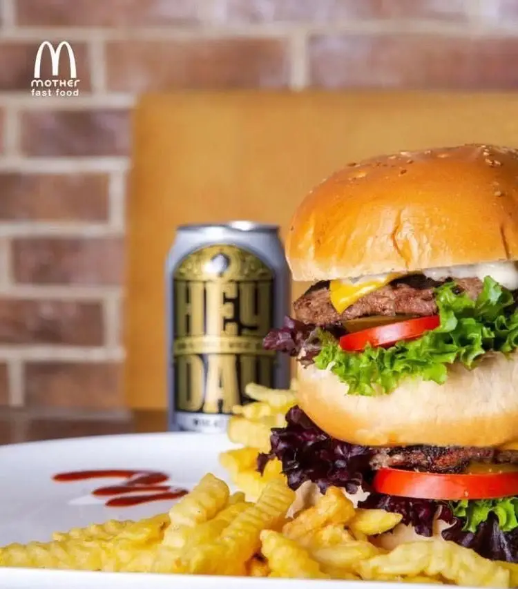 برگر گوشت دوبل جذاب فست فود مادر با پنیر، کاهو، گوجه و سس، همراه سیب‌زمینی ترد. غذای فست‌فود کامل.