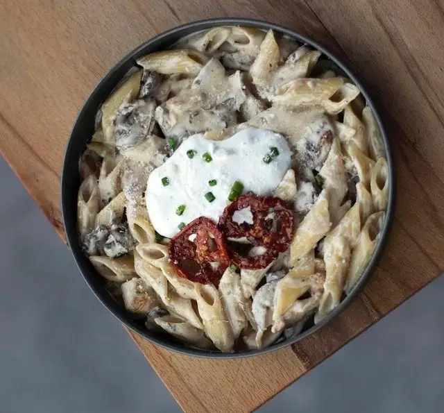 پاستا پنه کرمی با قارچ، سس غلیظ سفید، ماست چکیده و گوجه فرنگی خشک. یک غذای ایتالیایی لذیذ از كافه رستوران پلاك ٥.