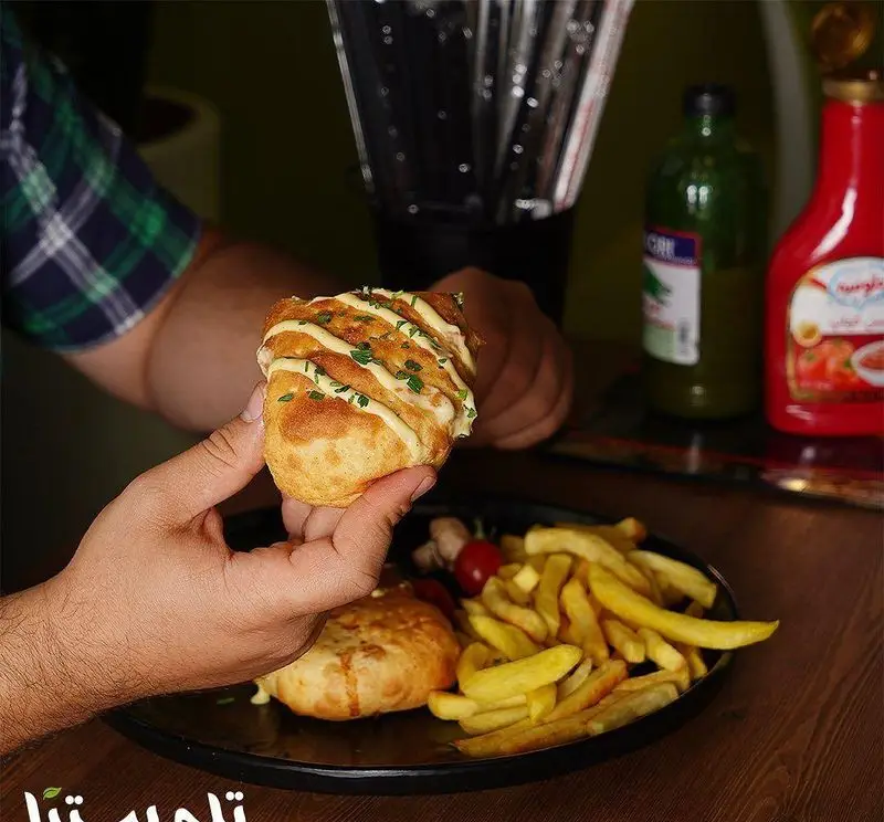 تصویری لذیذ از منوی فست فود تله پیتزا شامل لقمه جدید همراه با سیب زمینی سرخ کرده و مخلفات، تجربه ای فراموش نشدنی.