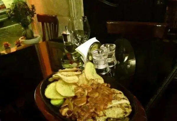 مرغ گریل با سس قارچ و چیپس سیب زمینی، غذایی محبوب در منوی رستوران فرنگی ژینر. محیطی دلنشین برای صرف شام لذیذ.