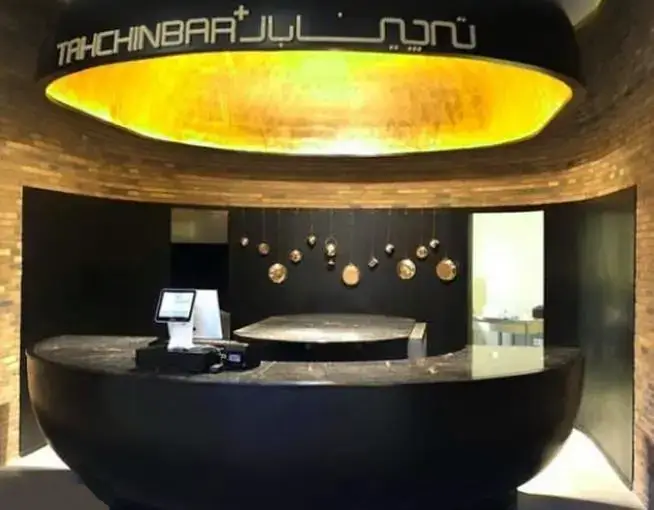 کانتر پذیرش و فضای داخلی رستوران مدرن طهچین‌بار در مجتمع تجاری ارگ، با طراحی شیک و نورپردازی جذاب.
