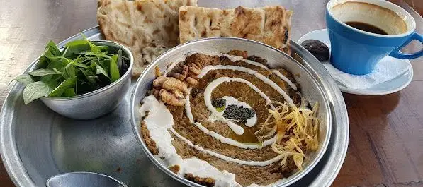 میز صبحانه کامل کافه روحی در باغ نگارستان؛ غذای سنتی، نان داغ، سبزی تازه و قهوه در فضایی دلنشین.