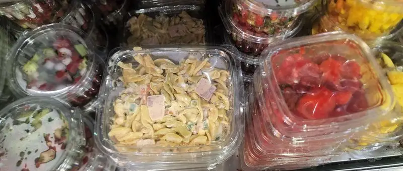 انواع سالاد و غذای آماده سوپ چی در ظروف پلاستیکی شفاف، شامل سالاد ماکارونی، سالاد میوه و سبزیجات تازه، مناسب برای خرید سریع در فروشگاه.