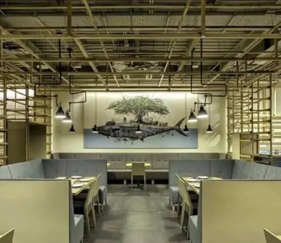 فضای داخلی مدرن و دلنشین کافی شاپ محفل با دکوراسیون صنعتی، سقف اکسپوز، مبلمان راحتی و دیوارنگاره هنری چشمگیر. مناسب قرارهای دوستانه و کاری.