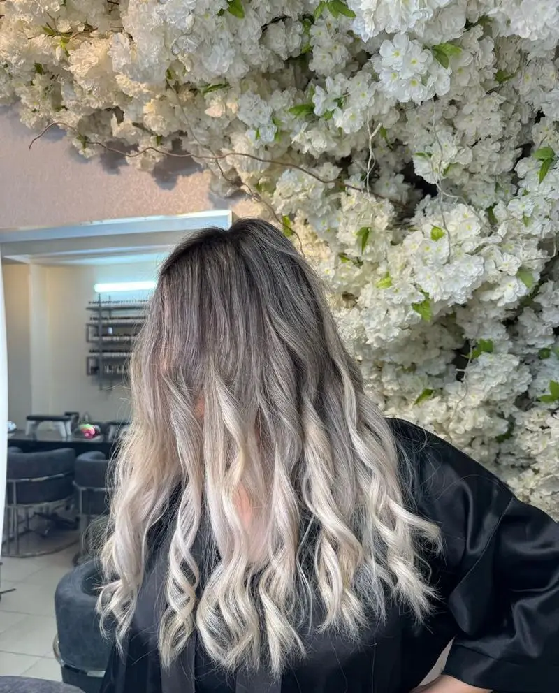 رنگ موی آمبره بلوند دودی زیبا و کرلی برای مشتری سالن زیبایی نینوش، مناسب برای ترندهای جدید و جذابیت خیره کننده.