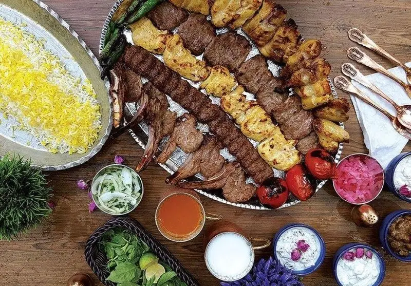 سفره‌ای شاهانه از انواع کباب‌های لذیذ و اصیل ایرانی شامل کوبیده، جوجه کباب و شیشلیک با چلو زعفرانی در کبابی سلطانی شعبه ۱