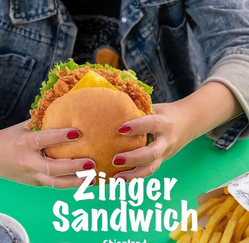 ساندویچ زینگر خوشمزه چیکولند با مرغ سوخاری و پنیر، آماده سرو در محیطی دلنشین. بهترین فست فود برای تجربه طعمی عالی و سفارش آسان.